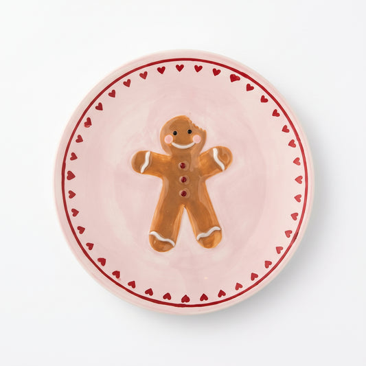 Kleines Steingut-Teller Binna in Rosé mit handbemaltem Lebkuchen-Motiv auf weißem Hintergrund.